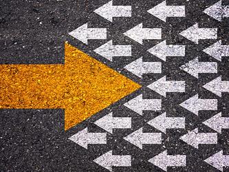 large yellow arrow pointing in the opposite direction from multiple smaller white arrows